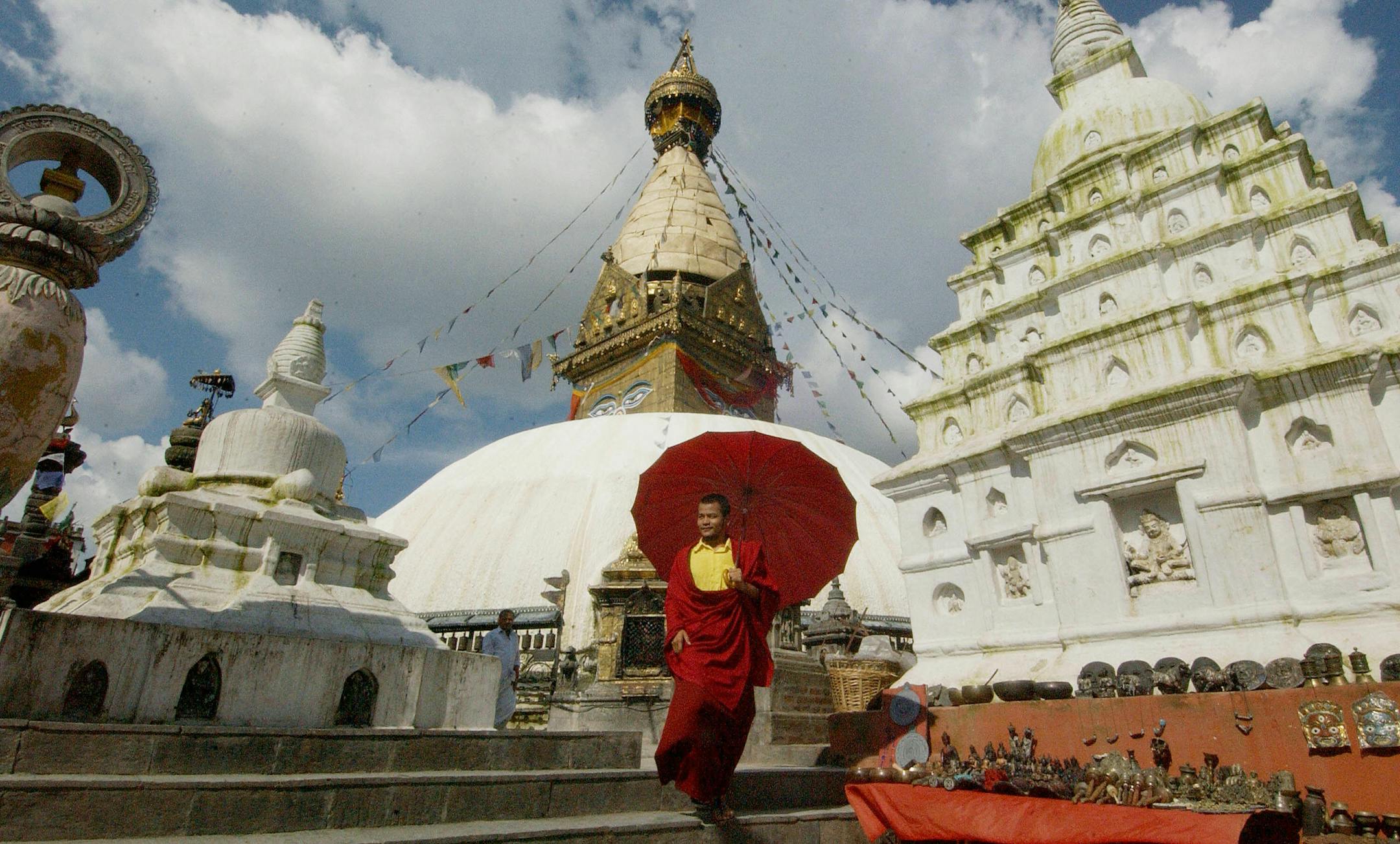 A Buddhist monk walked among the various shrines at the Swayambunath Temple in Katmandu. Although the site is considered Buddhist, the place is revered by both Buddhists and Hindus.