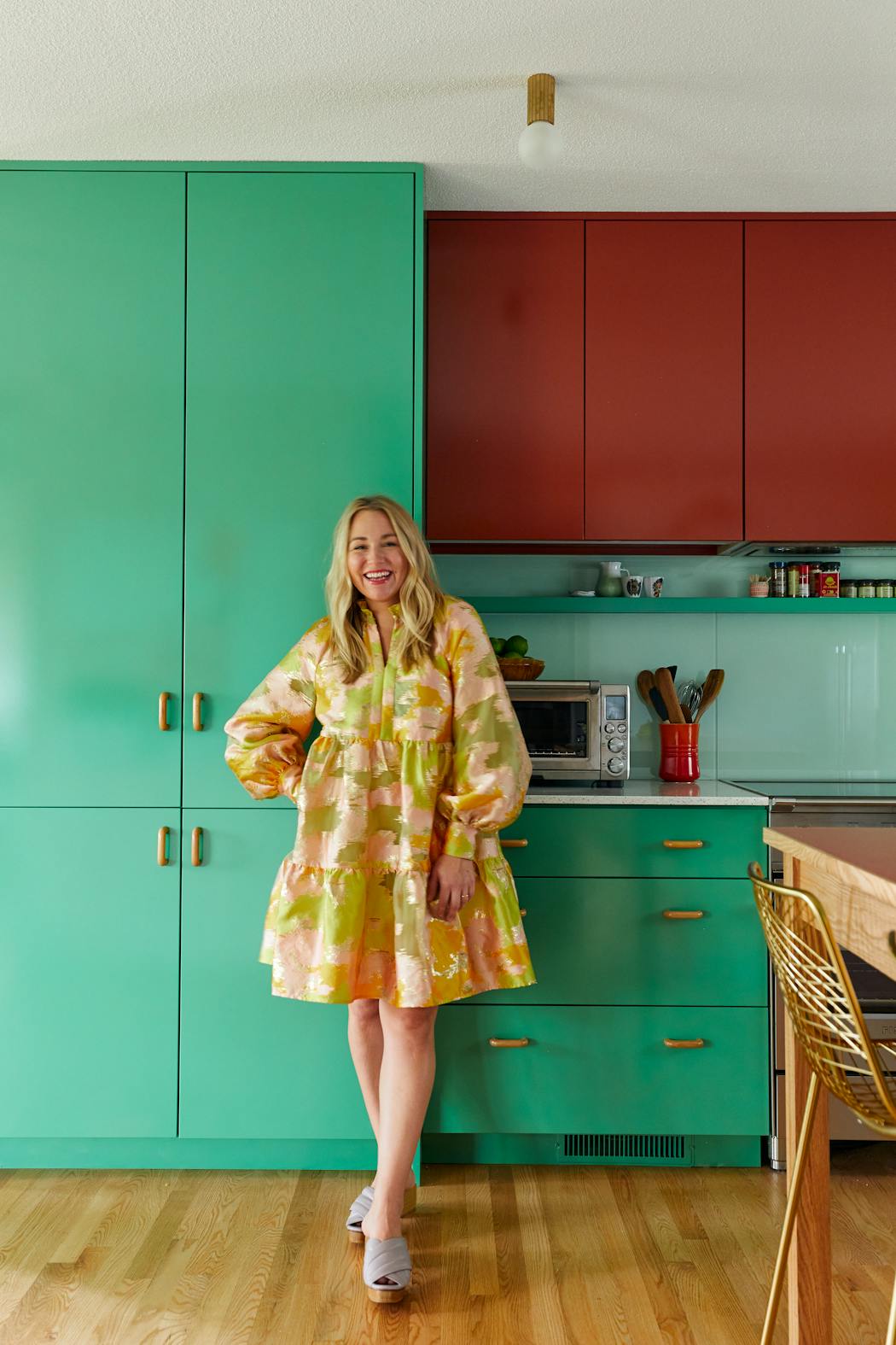 Prospect Refuge Studio designer Victoria Sass in a kitchen she transformed in Minneapolis' Bryn Mawr. Mint, red, lavender and gold hues are inspired by the 2020 Gucci Spring Summer collection. The design creates a color-block effect.