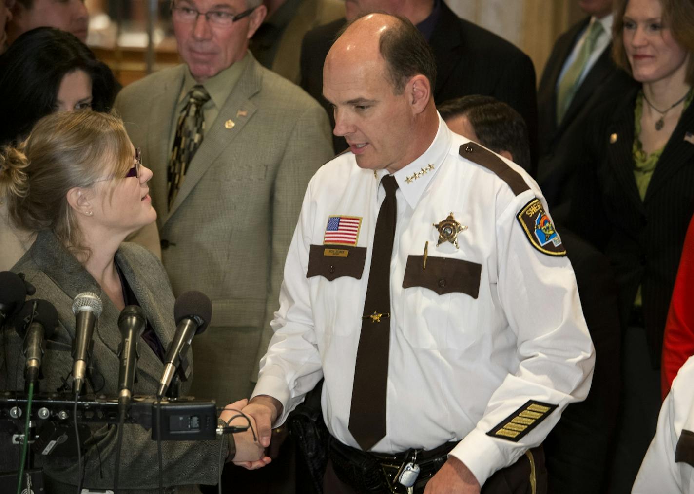 Rep. Debra Hilstrom shook hands with Hennepin County Sheriff Rich Stanek after the announcement. A bipartisan group of lawmakers and members of the Minnesota Sheriff's Association stood in front of the House chambers to introduce an alternative gun bill that doesn't include background checks. The bill's author is Rep. Debra Hilstrom, center and is supported by Sen Tony Cornish, a gun rights advocate and Hennepin County Sheriff Rich Stanek.