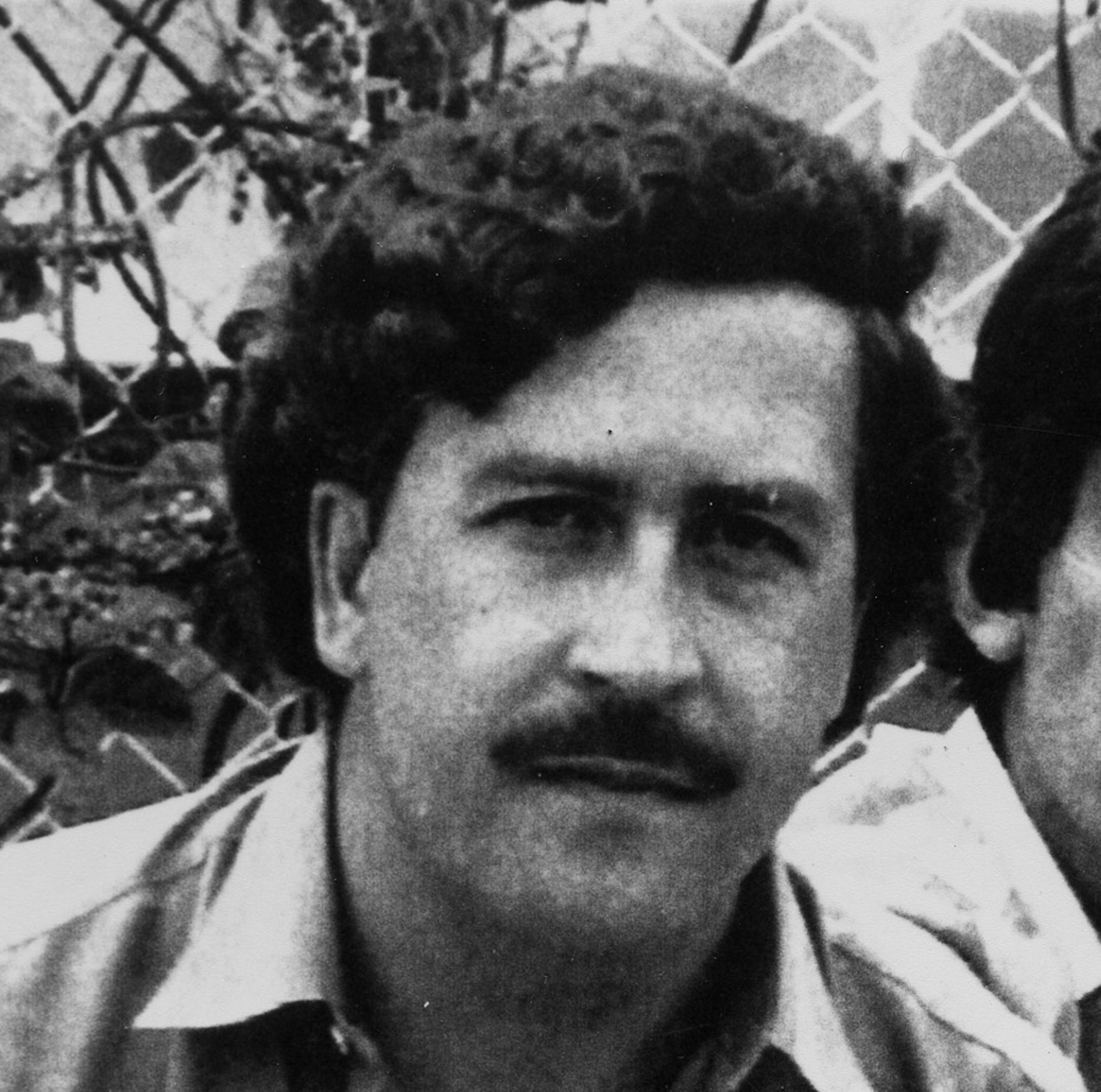 Pablo Escobar, left, 41-year-old billionaire leader of the Medellin drug cartel, poses at a soccer game in Medellin, Colombia, in 1983. At right is an unidentified bodyguard. (AP Photo) ORG XMIT: APHS143