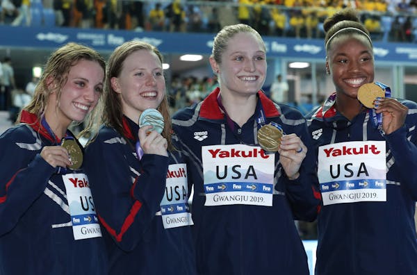The United States women's 4x100m medley relay team (from left, Lakeville's Regan Smith, Lilly King, Kelsi Dahlia and Simone Manuel) posed with their g
