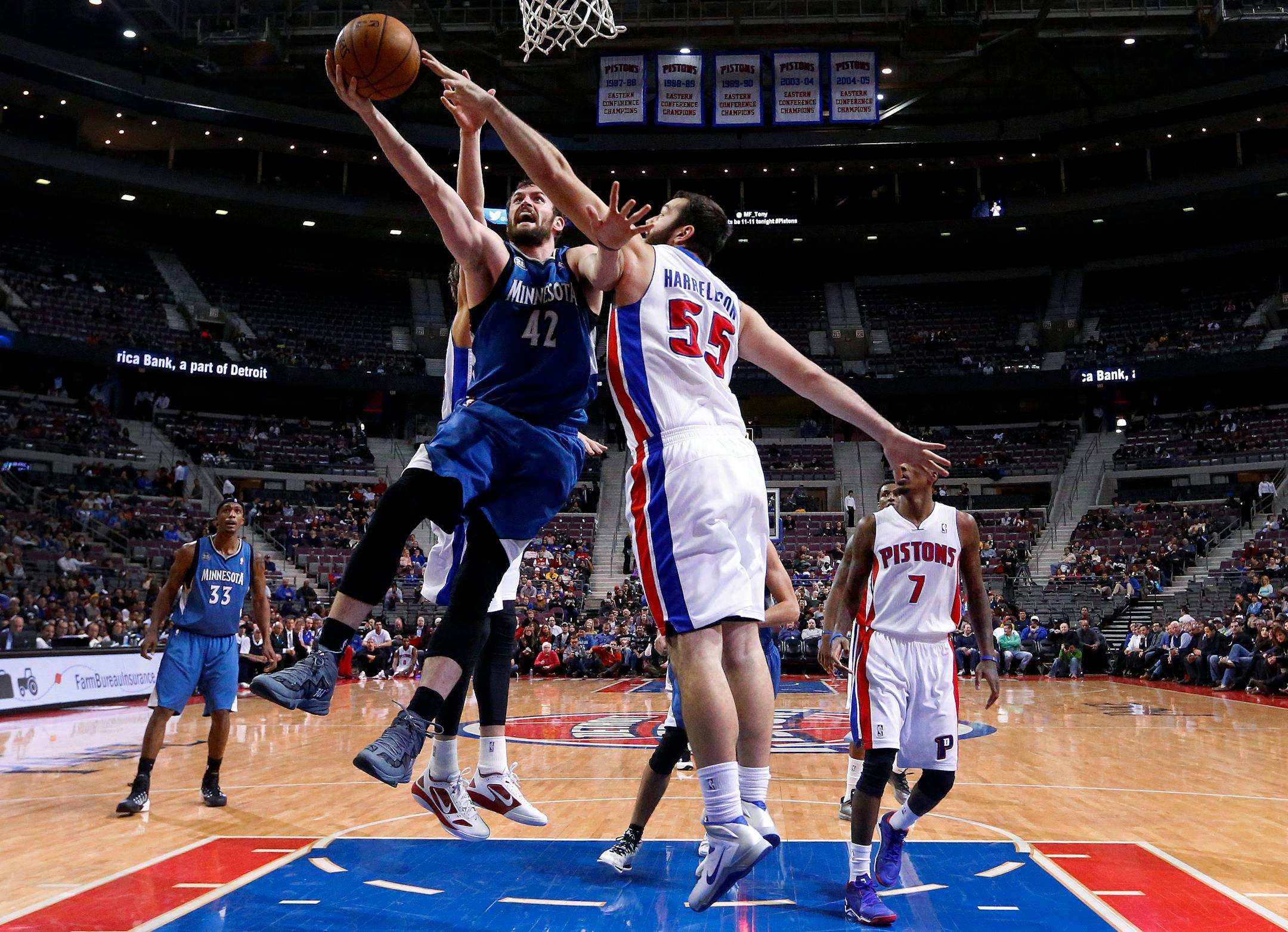 Minnesota Timberwolves power forward Kevin Love (42) drives on Detroit Pistons power forward Josh Harrellson (55) in the first half of an NBA basketball game in Auburn Hills, Mich., Tuesday, Dec. 10, 2013. (AP Photo/Paul Sancya)