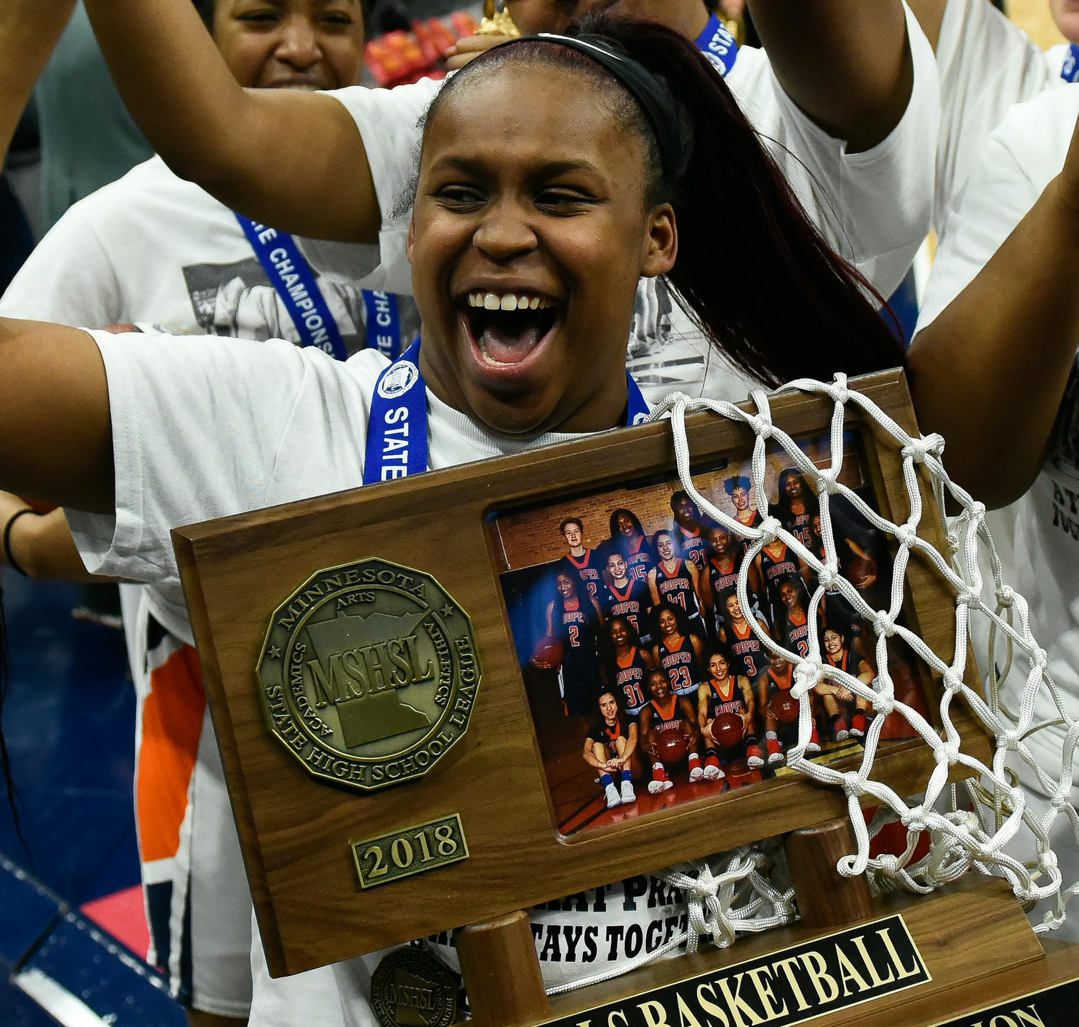Robbinsdale Cooper players, including guard Ty'neecia Longs (4), holding trophy, celebrated their team's 49-37 victory over Northfield to win the Class 3A championship title Saturday. ] AARON LAVINSKY ï aaron.lavinsky@startribune.com Robbinsdale Cooper played Northfield in the girlsí basketball Class 3A state championship game on Saturday, March 17, 2018 at Target Center in Minneapolis, Min