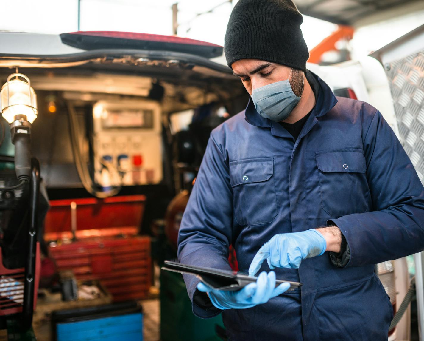 mechanic in front of the van with face mask