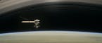 This image made available by NASA in April 2017 shows a still from the short film "Cassini's Grand Finale," with the spacecraft diving between Saturn 
