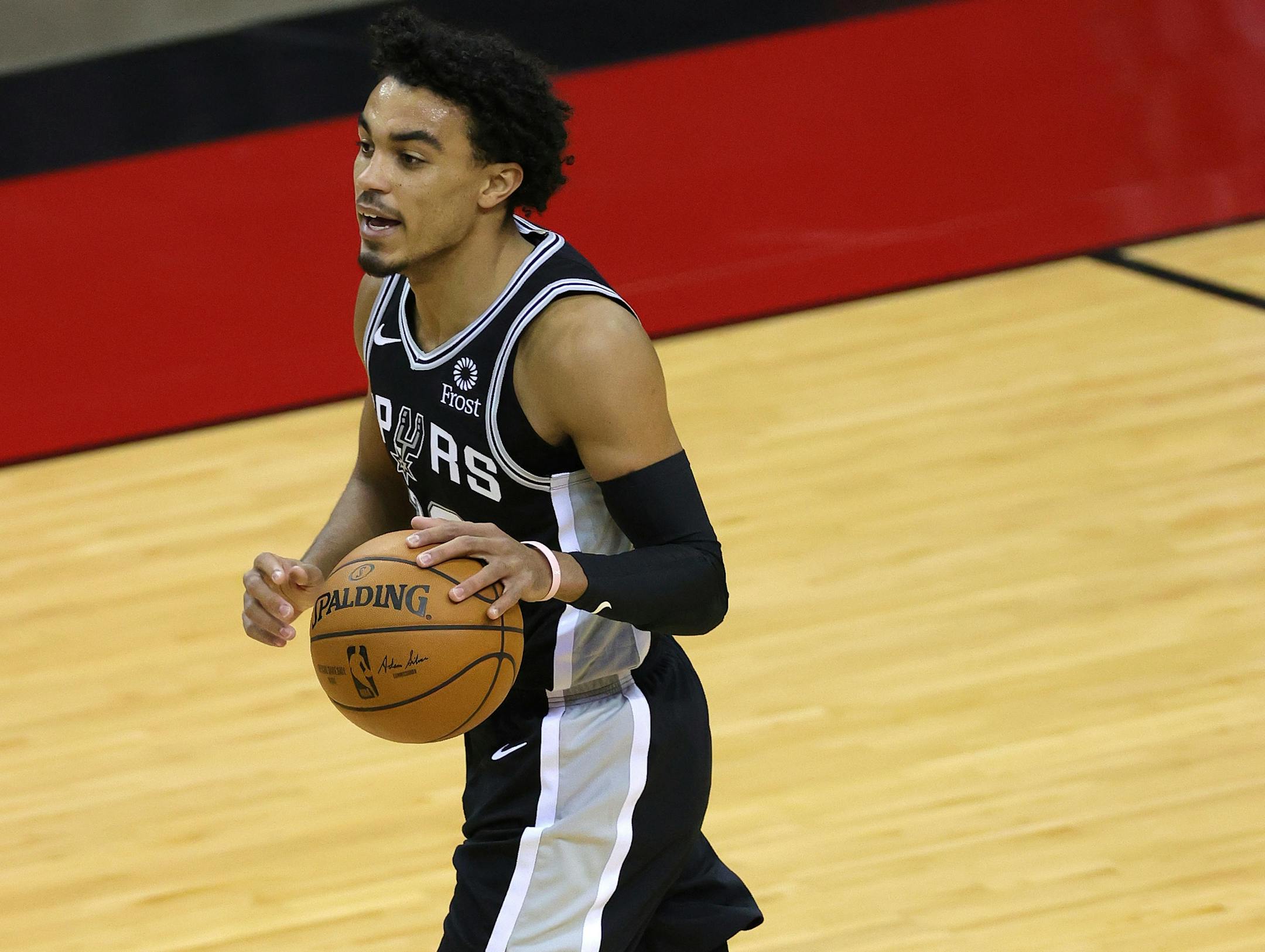 San Antonio Spurs' Tre Jones controls the ball during the fourth quarter of an NBA basketball game against the Houston Rockets in Houston, Thursday, Dec. 17, 2020. (Carmen Mandato/Pool Photo via AP)