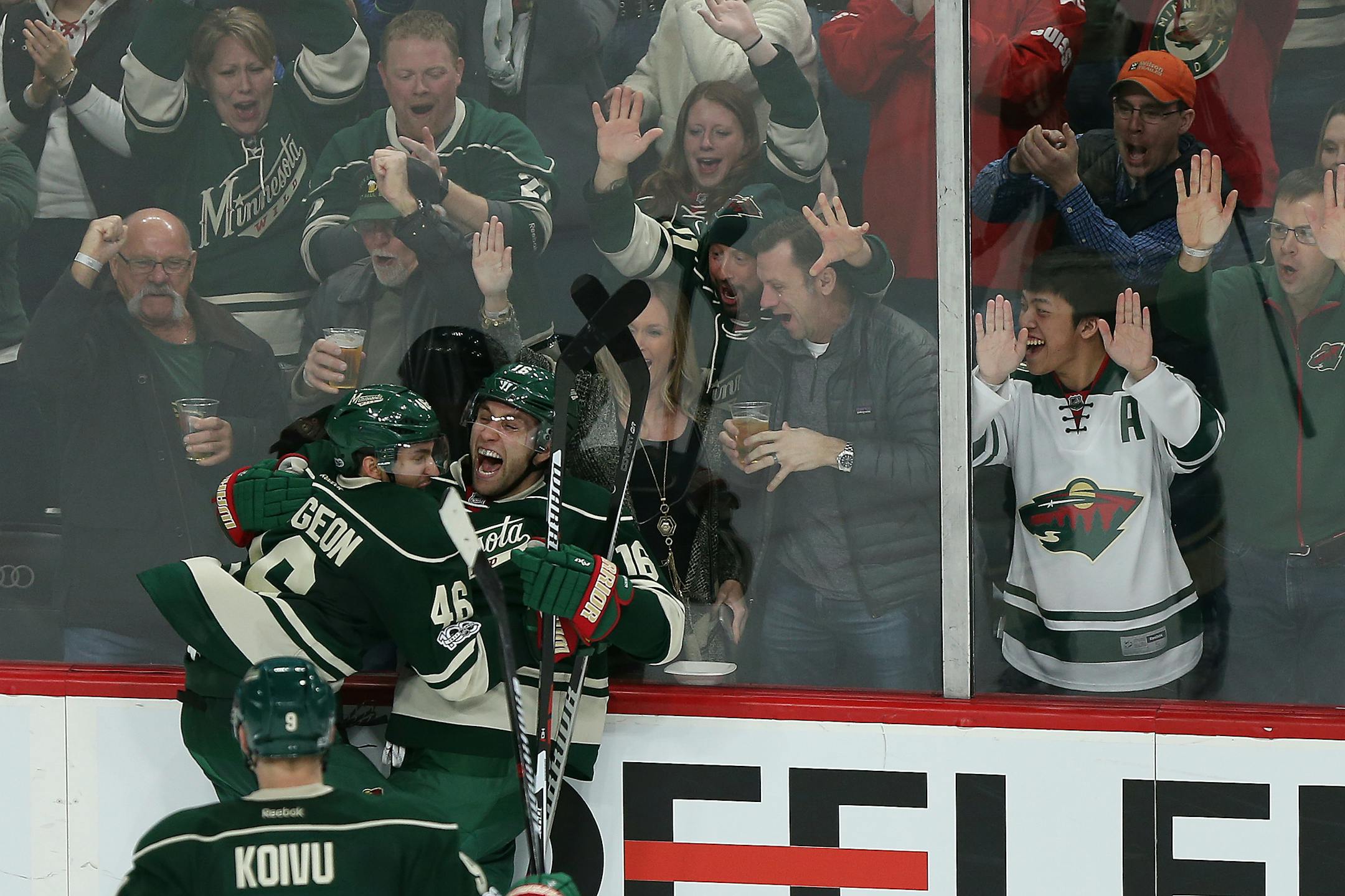 Minnesota Wild's Jason Zucker celebrates with teammate Jared Spurgeon after Zucker scored a goal against the Anaheim Ducks during the third period of an NHL hockey game Saturday, Jan. 21, 2017, in St. Paul, Minn. The Wild won 5-3. (AP Photo/Stacy Bengs)