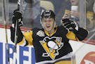Pittsburgh Penguins' Jake Guentzel celebrates his first goal in the NHL on his first shot in his first NHL shift during the first period of an NHL hoc