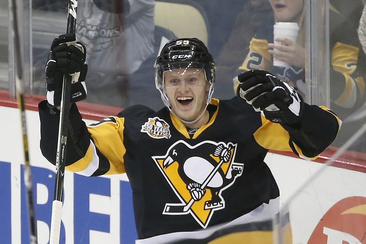 Pittsburgh Penguins' Jake Guentzel celebrates his first goal in the NHL on his first shot in his first NHL shift during the first period of an NHL hockey game against the New York Rangers in Pittsburgh, Monday, Nov. 21, 2016.