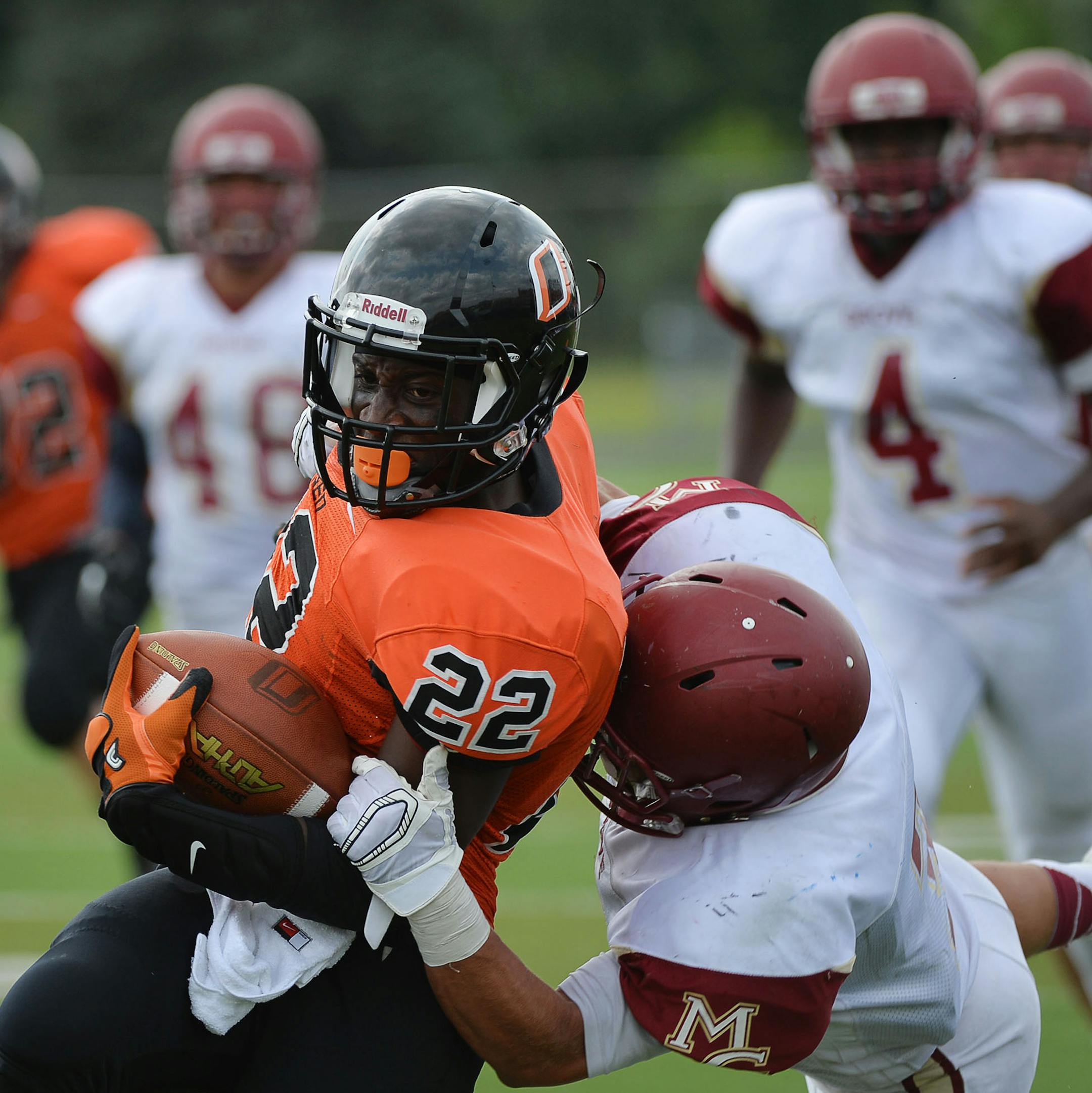 Osseo Running Back Prince G Kruah was tackled by Maple Grove Running Back/Defensive Back Isaac Collins during the 2nd quarter Maple Grove vs Osseo football game at Osseo High School in Osseo, Minn. on Saturday August 22, 2015. ] RACHEL WOOLF · rachel.woolf@startribune.com Osseo defeated Maple Grove 22-15.