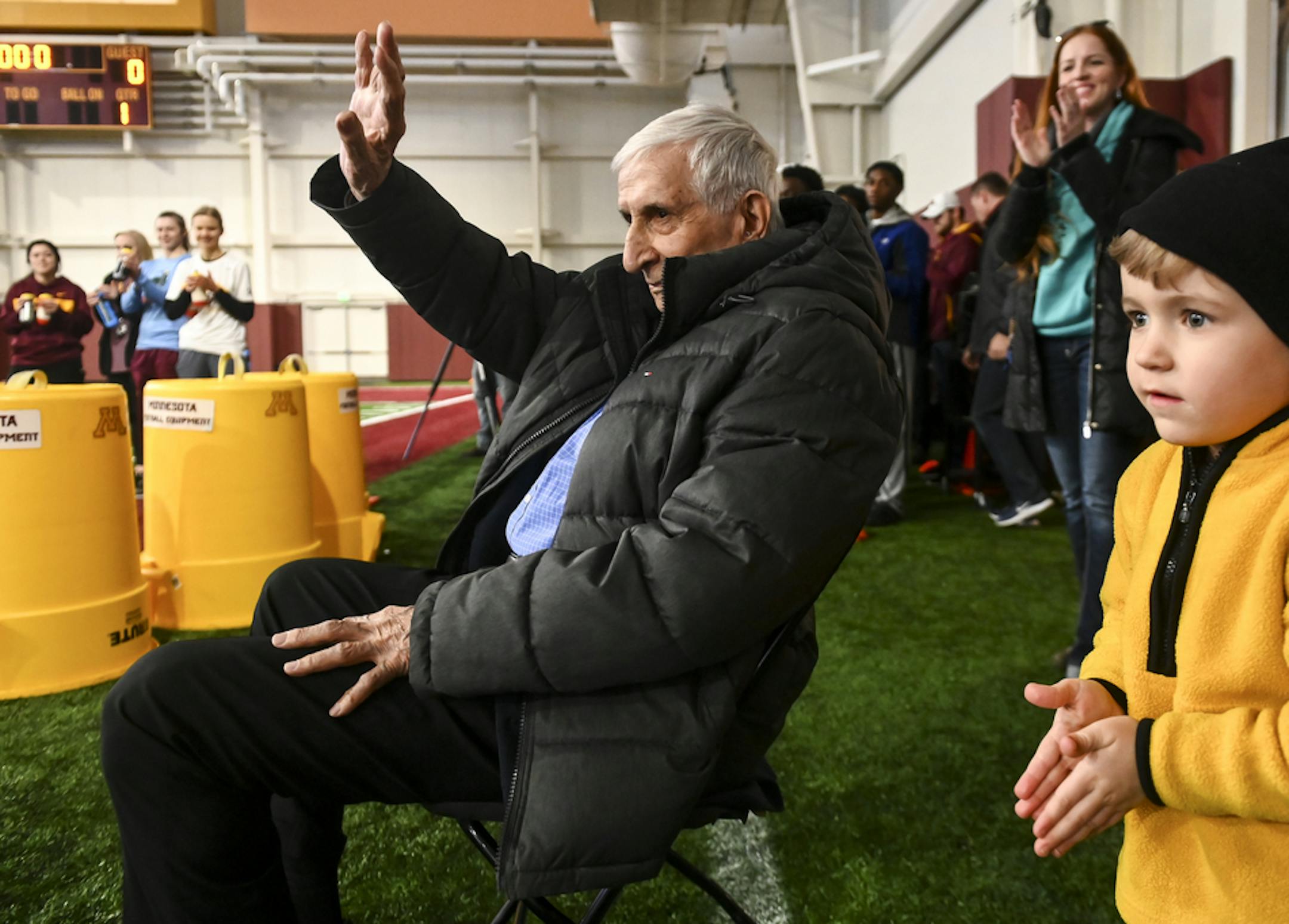 Sid Hartman waved to recognize the Gophers football team and fans after they sang him happy birthday at Friday's practice. ] Aaron Lavinsky &#xa5; aaron.lavinsky@startribune.com The University of Minnesota Golden Gophers football team held an open practice on Friday, March 15, 2019 at the Athletes Village's Football Indoor Practice Facility in Minneapolis, Minn.