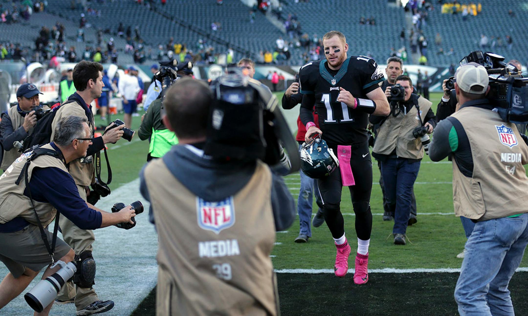 Eagles quarterback Carson Wentz left the field through a swarm of photographers after beating the Vikings 21-10.