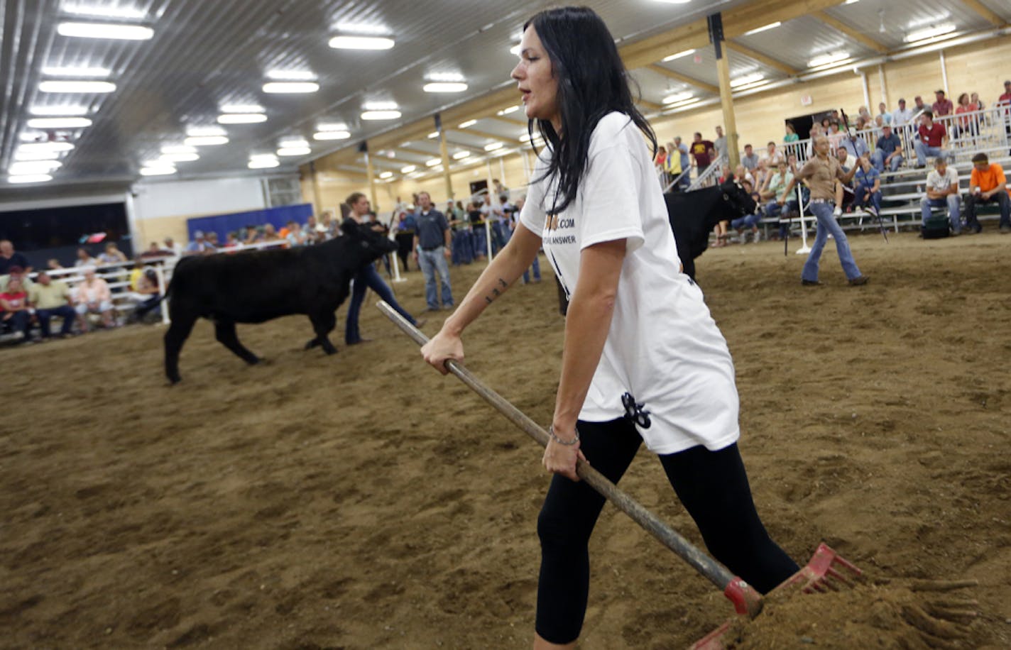 Lindsey Krieger of DoodyCalls cleaned up during cattle judging at the Minnesota State Fair. Among its duties, DoodyCalls removes manure from all the barns.