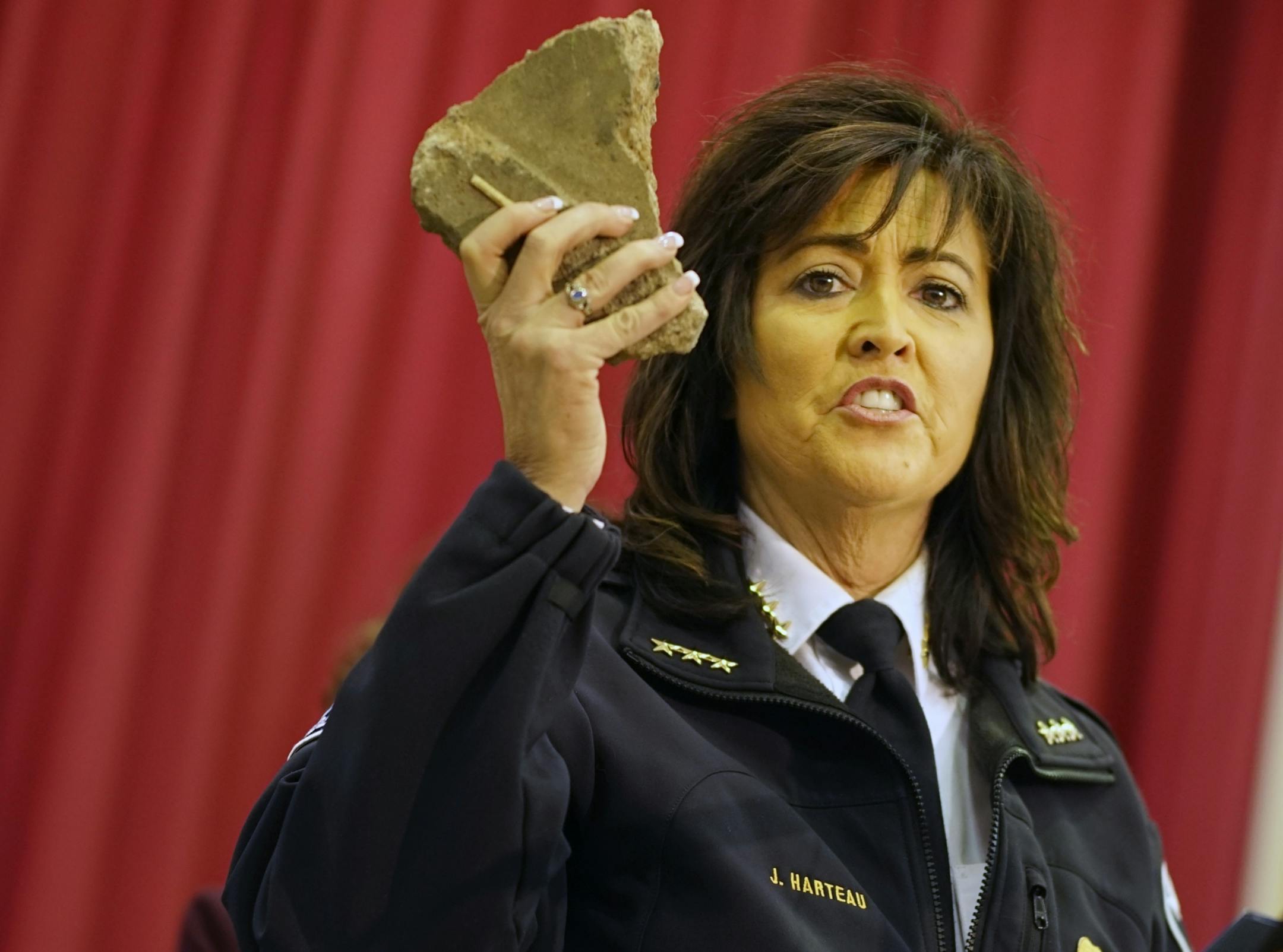 At the North Minneapolis command center, Minneapolis Police Chief showed evidence of a rock thrown at police during the protests at the 4th Precinct over the death of Jamar Clark .