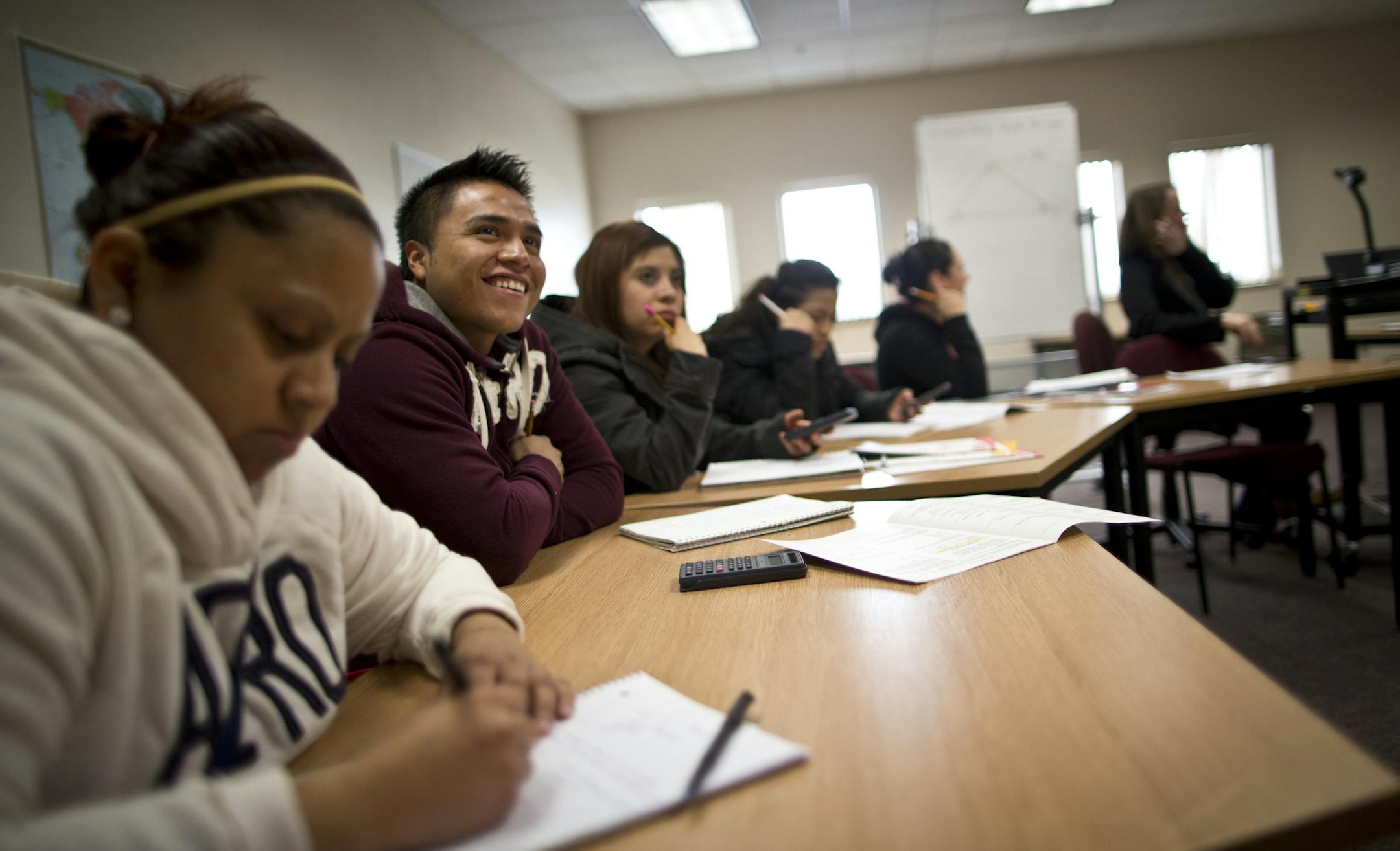 Mateo Favian, 25, smiled after he figured out a math problem during a GED class at the Northfield Community Resource Center on Tuesday, March 12, 2013, in Northfield, Minn. ] (RENEE JONES SCHNEIDER * reneejones@startribune.com)