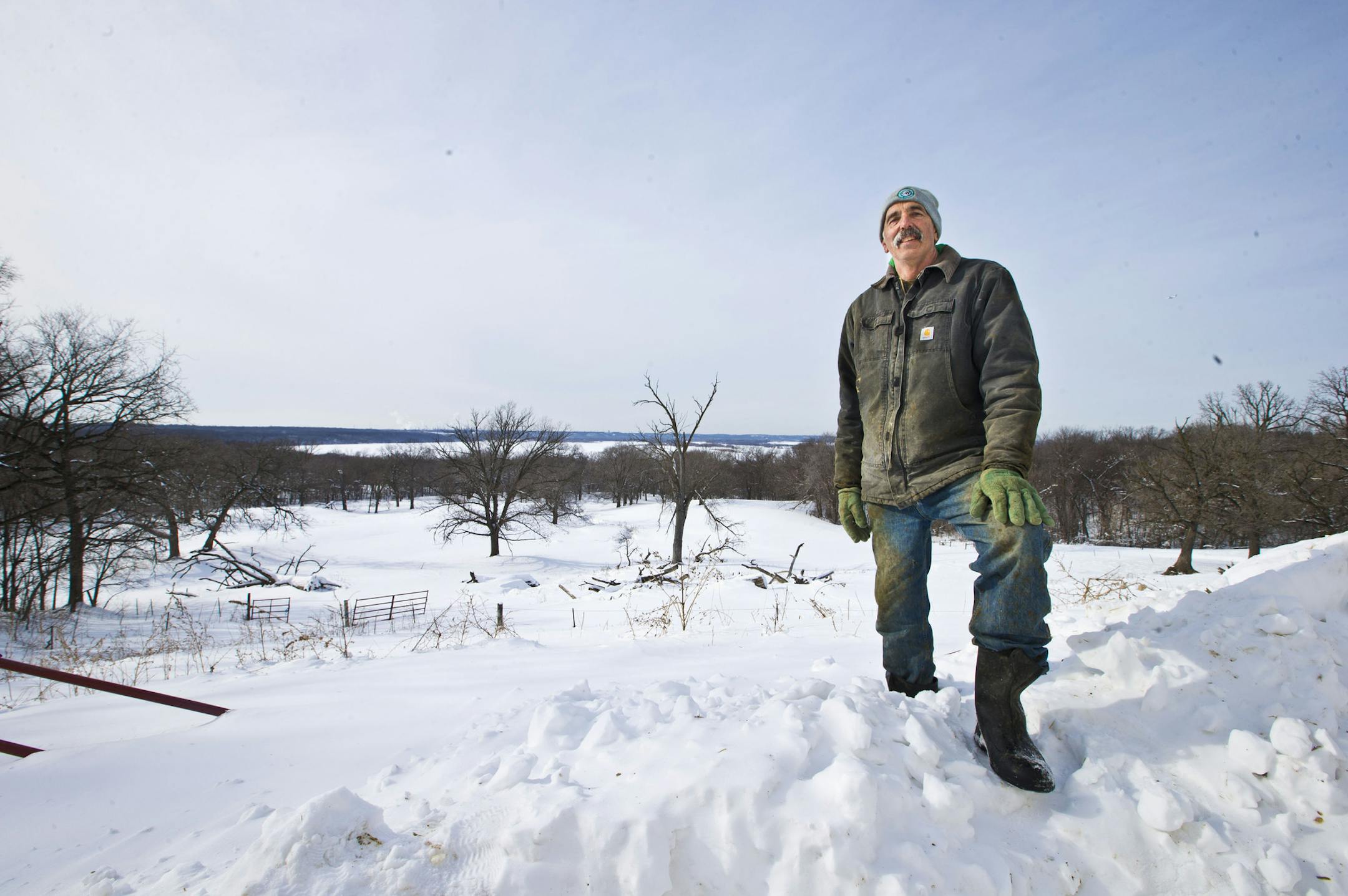 William Sorg stood on his land with the view of Spring Lake in Hastings, Minn., on Monday, February 24. 2014. Sorg a dairy farmer in Hastings is facing condemnation on 77 acres from his landholdings overlooking the Mississippi River. The farm has been in his family 118 years. He won't lose the farm but he will lose the woods and the river front that goes with the land if the condemnation goes through. ] (RENEE JONES SCHNEIDER • reneejones@startribune.com)