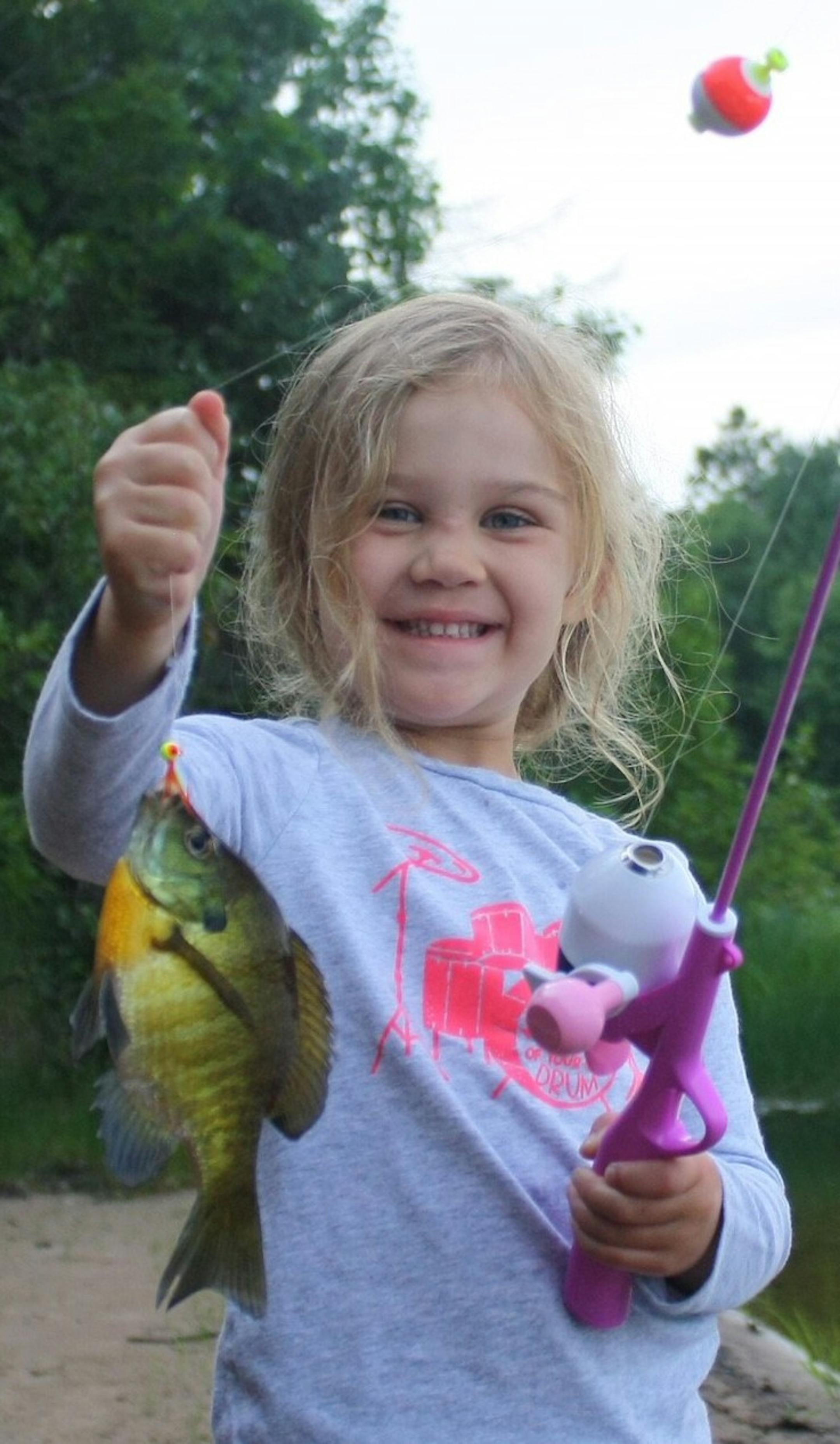 Fishing with an aunt on their secret beach Net Lake in Pine County, 4-year old Natalie Farmer, of Andover, caught her first sunfish using a wax worm and her Repunzel fishing pole.  She gave the sunfish a kiss before releasing it back into the lake.