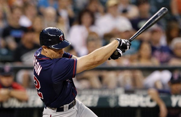 Minnesota Twins' Matt Carson singles in a run against the Seattle Mariners in the fifth inning of a baseball game, Friday, Aug. 17, 2012, in Seattle.