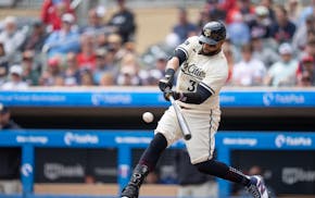 Minnesota Twins first baseman Carlos Santana hits an RBI single in the first inning that scored outfielder Manuel Margot.