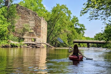 Paddling the upper Cannon River past mill ruins in Dundas, Minn.