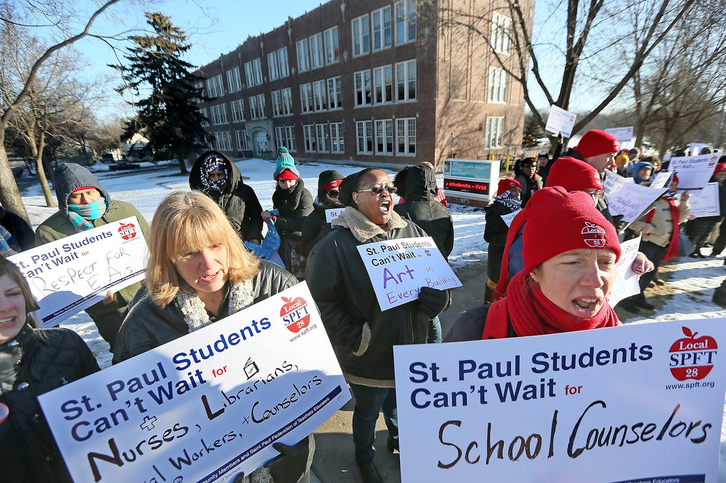 Yolanda Roth, center, yelled in support of teachers and parents as they gathered at the American Indian Magnet School for a rally Wednesday in St. Paul.