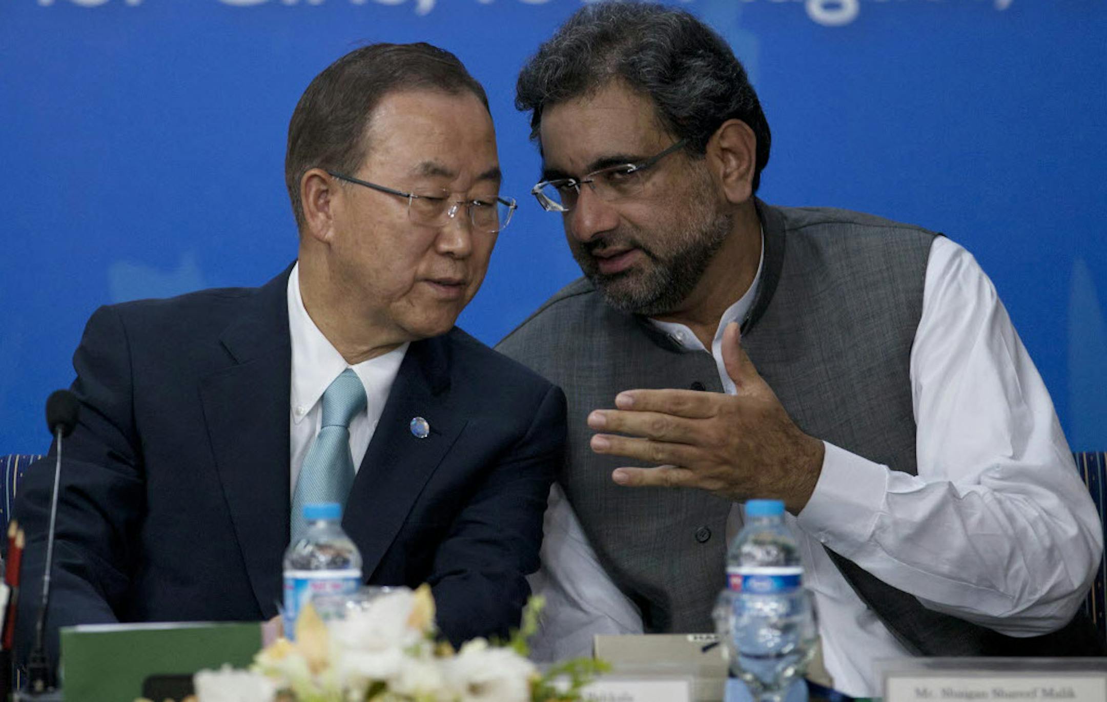 Pakistan's Petroleum and Natural Resources Minister Shahid Khaqan Abbasi, right, talks with visiting U.N. Secretary-General Ban Ki-moon during his visit to a college to address students in Islamabad, Pakistan, Tuesday.
