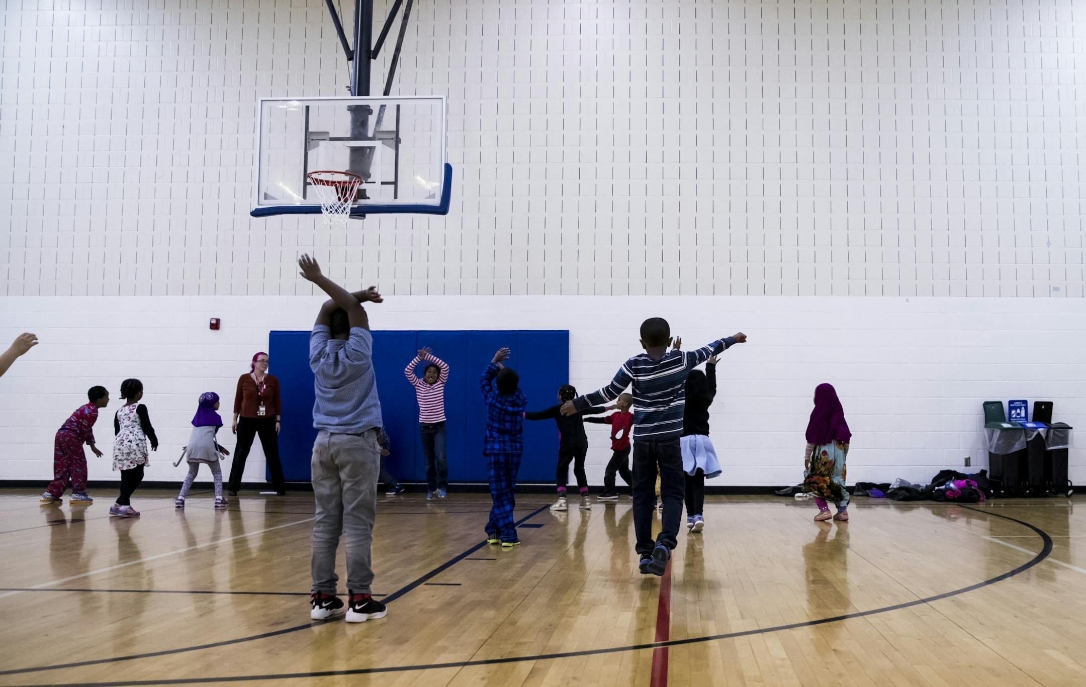 Children from a local school use the gym during physical education at the Brian Coyle Center on Monday, October 24, 2016, in Minneapolis, Minn.