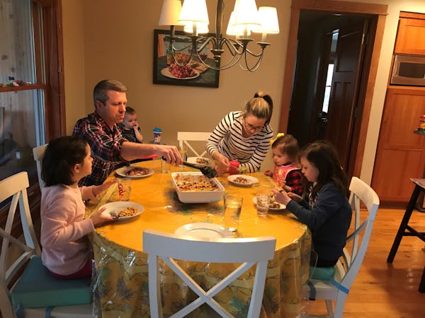 Christina and Mike Goetz of Independence are juggling busy careers and family duties as they adjust to working from home, remote schooling with their 
