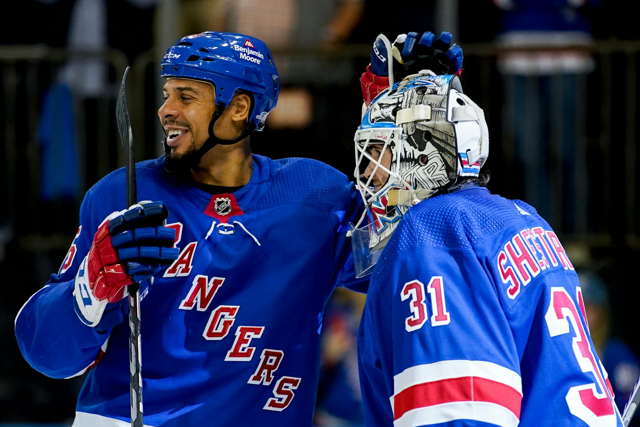 New York Rangers right wing Ryan Reaves, left, congratulated goaltender Igor Shesterkin, who made 25 saves in Tuesday night's season-opening victory.
