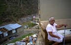 2017 AP LATIN AMERICA YEAR END PHOTOS - Juana Sortre Vazquez sits on her soaked couch in what remains of her home, destroyed by Hurricane Maria in the