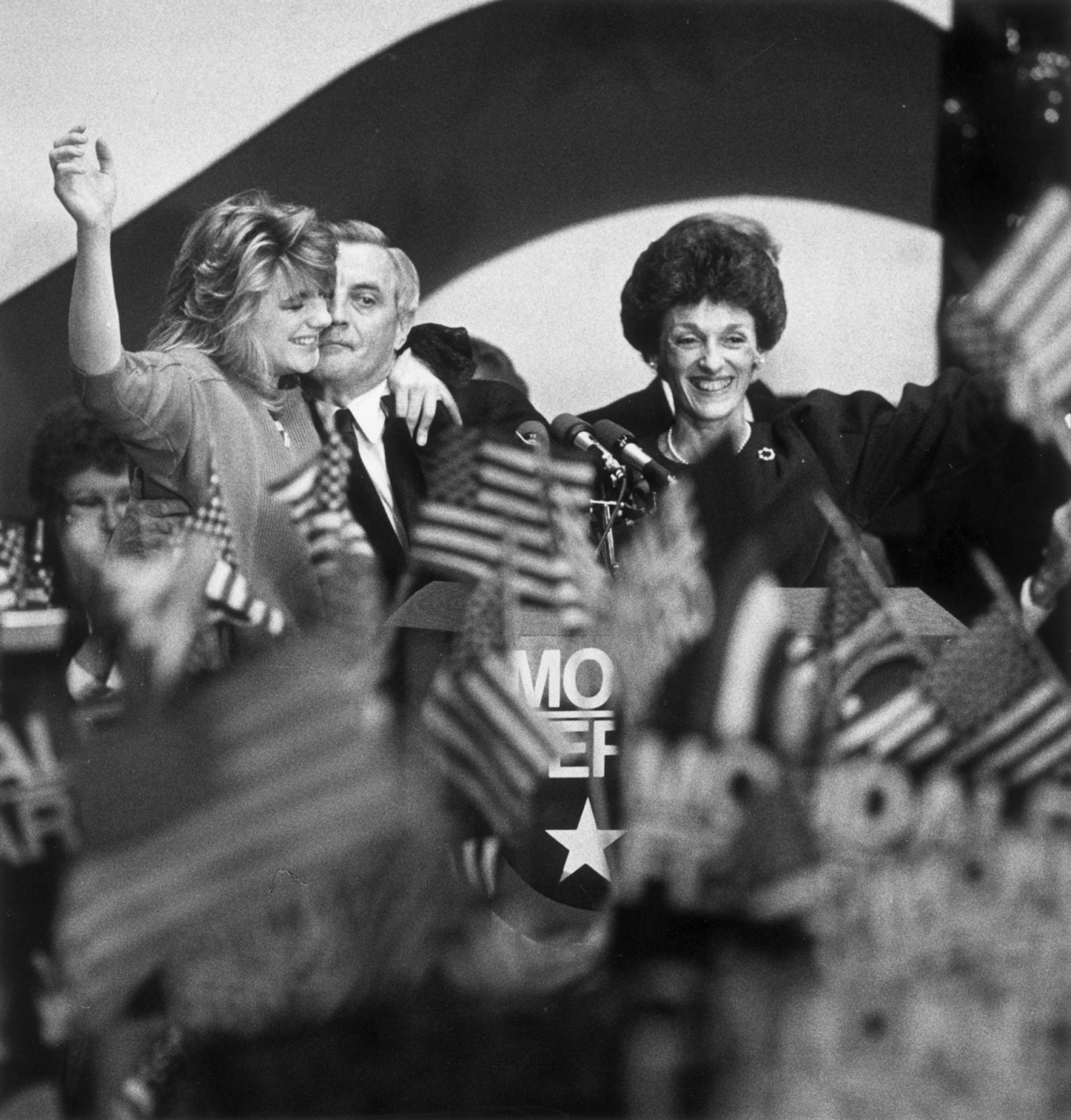 ~-Walter Mondale is shown being embraced by his daughter Eleanor, with his wife Joan at his side, as supporters wave after Mondale's concession speech after the 1984 presidential election -- photo taken November 6, 1984, by Star Tribune staff photographer Darlene Pfister.