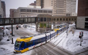 A Green Line train leaves the Central Station building that connects the light-rail station to the city’s skyway system Tuesday afternoon, March 26,