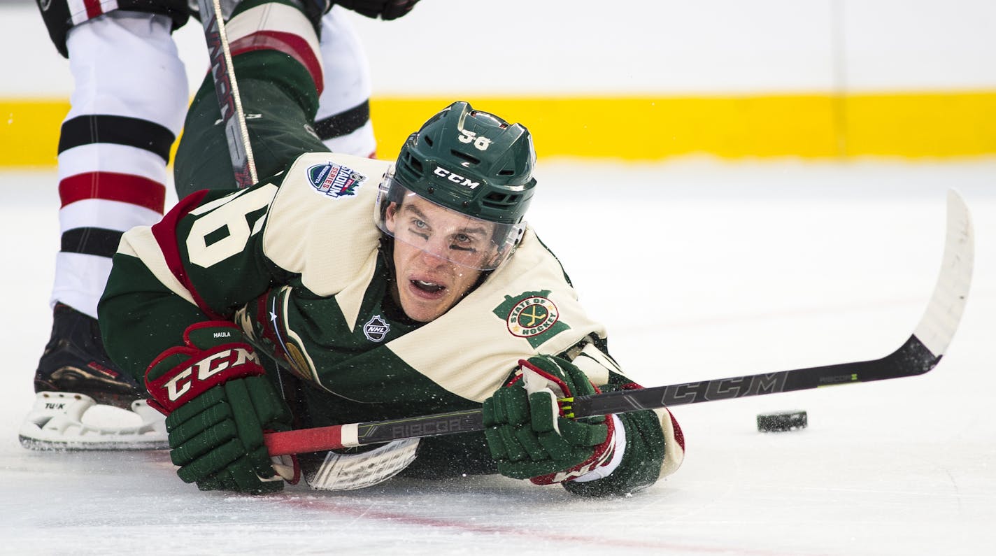 The puck slid into the goal as Minnesota Wild left wing Erik Haula (56) fell to the ice after taking a shot on an empty net, bringing the Wild's score to 6-1 over the Blackhawks in the third period. ] (AARON LAVINSKY/STAR TRIBUNE) aaron.lavinsky@startribune.com The 2016 Coors Light NHL Stadium Series game between the Minnesota Wild and the Chicago Blackhawks was held Sunday, Feb. 21, 2016 at TCF Bank Stadium in Minneapolis, Minn.