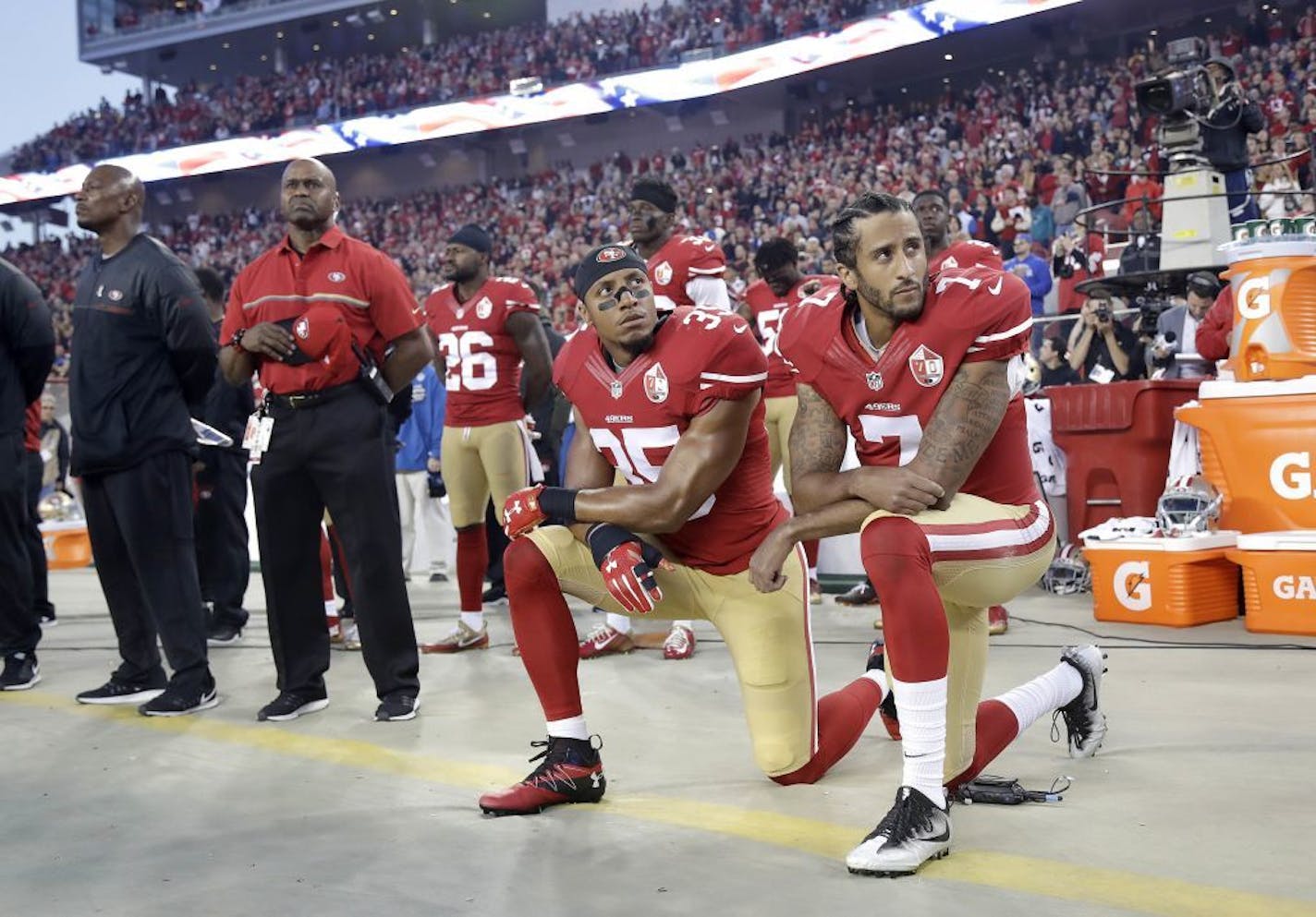 FILE - In this Sept. 12, 2016, file photo, San Francisco 49ers safety Eric Reid (35) and quarterback Colin Kaepernick (7) kneel during the national anthem before an NFL football game against the Los Angeles Rams in Santa Clara, Calif. Despite their vastly divergent methods, Colin Kaepernick and LeBron James helped set a stake in the ground, declaring to athletes across all sports that their platforms could be used for more than fun and games in the 21st century.