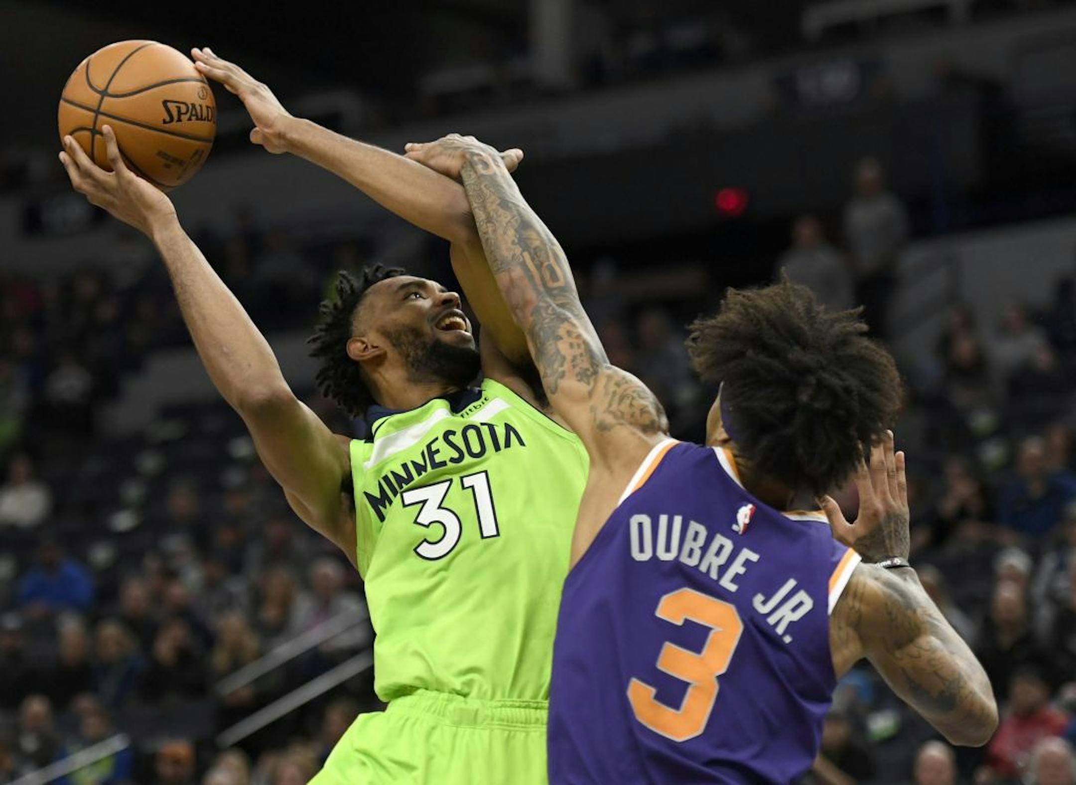Phoenix Suns' Kelly Oubre Jr. (3) fouls Minnesota Timberwolves' Keita Bates-Diop (31) during the fourth quarter of an NBA basketball game Saturday, Nov. 23, 2019, in Minneapolis. The Suns won 100-98.