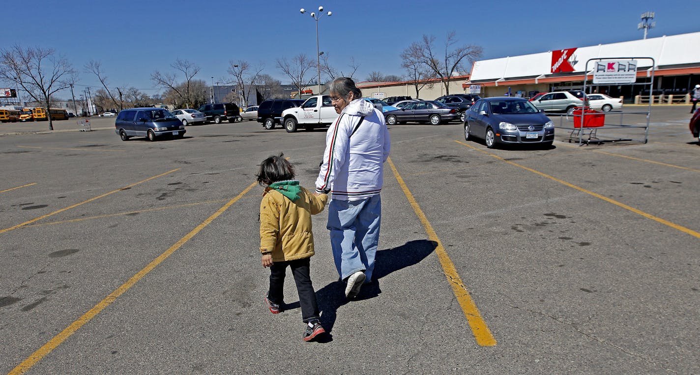 Margaret Percy and her grandson Jordan One Feather played as they made their way to Kmart near the corner of Nicollet and Lake Streets, Tuesday, April 15, 2014 in Minneapolis, MN. Minneapolis officials discussed Tuesday a redevelopment plan that would reverse one of the biggest planning blunders in city history: closing Nicollet Avenue at Lake Street. Percy said that there is a huge need for those stores to remain open for those who walk. ] (ELIZABETH FLORES/STAR TRIBUNE) ELIZABETH FLORES &#x202