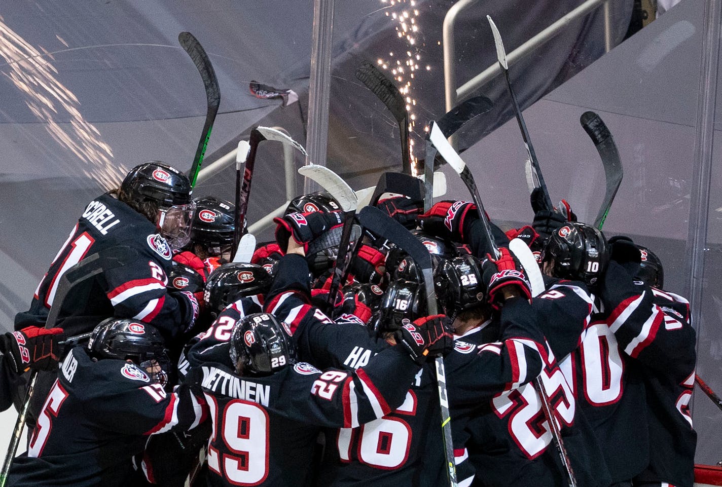 St. Cloud State players swarmed goaltender David Hrenak (34) after they defeated Minnesota State in the national semi-final on Thursday. ]