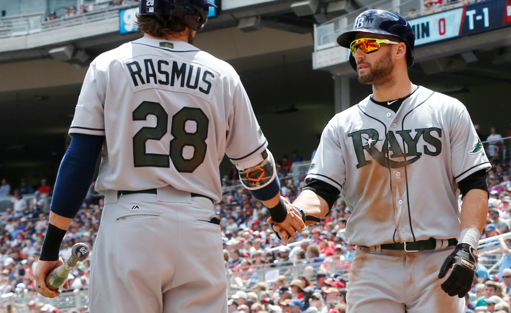 Tampa Bay Rays' Kevin Kiermaier, right, is congratulated by Colby Rasmus after scoring after Steven Souza Jr's. grounded into a fielder's choice off Minnesota Twins pitcher Kyle Gibson in the first inning of a baseball game Sunday, May 28, 2017 in Minneapolis. (AP Photo/Jim Mone)
