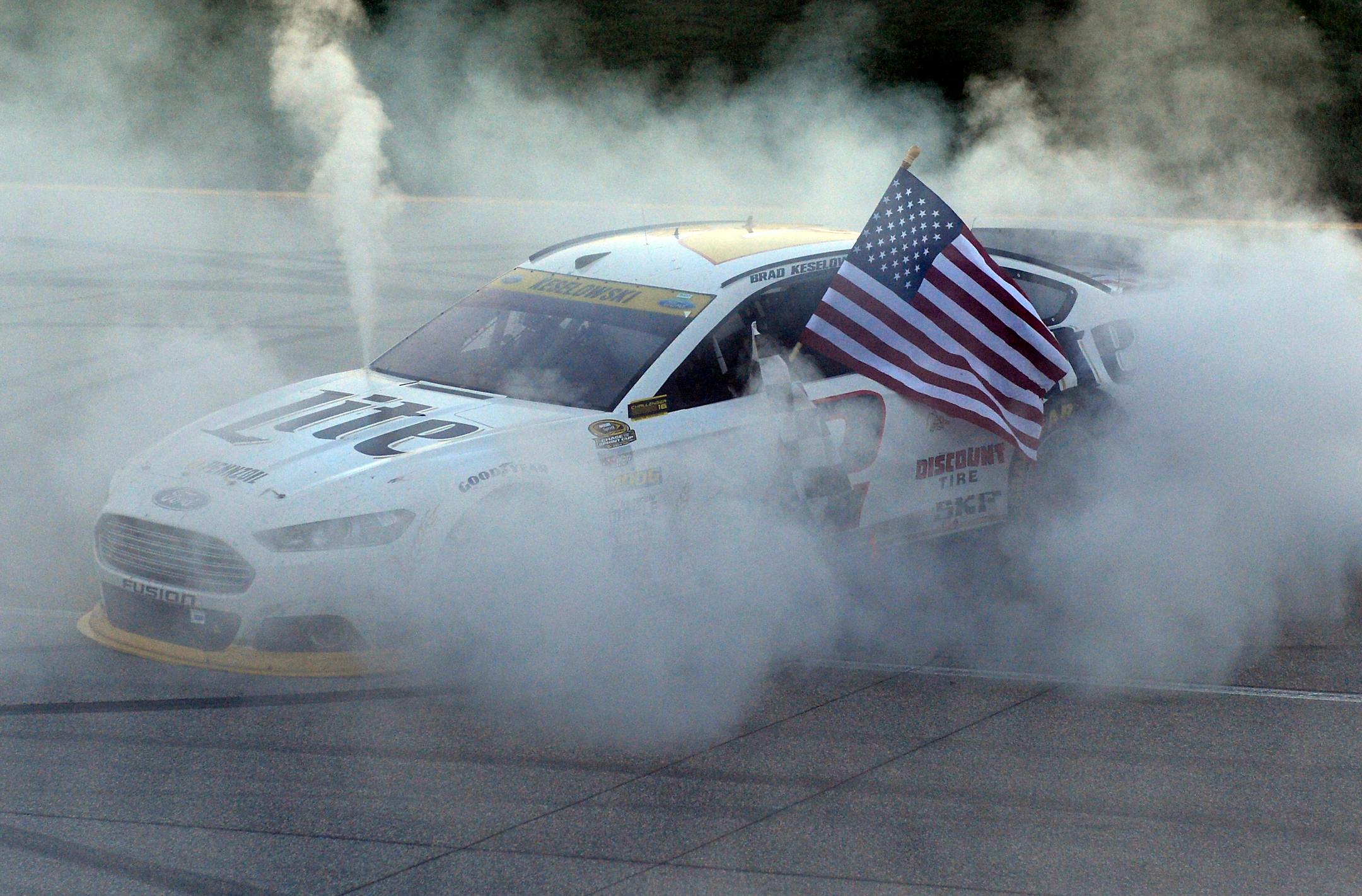 Brad Keselowski (2) celebrates his win with a burnout after winning the NASCAR Sprint Cup series auto race at Chicagoland Speedway in Joliet, Ill., Sunday, Sept. 14, 2014. (AP Photo/Paul J. Bergstrom)