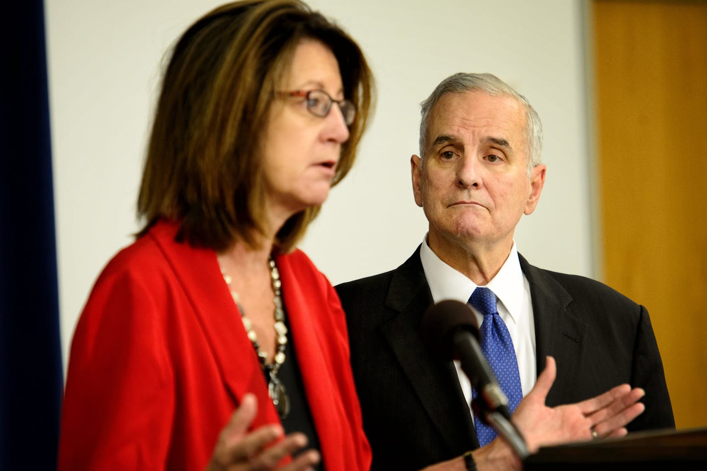 Gov. Mark Dayton listened as Commissioner Lucinda Jesson answered questions Monday morning.