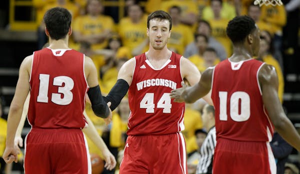 Wisconsin's Frank Kaminsky (44) is congratulated by teammates Duje Dukan (13) and Nigel Hayes (10) after drawing a goal against Iowa's Adam Woodbury d