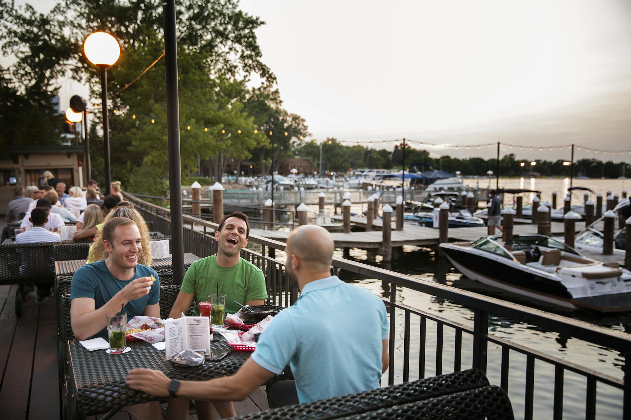 Isaac Bar, clockwise from left, of Minneapolis, Tyler Smith, of Minneapolis, and Micah Berman of St. Louis Park eat and drink on the patio at Maynards in Excelsior on Tuesday, July 1, 2015. ] LEILA NAVIDI leila.navidi@startribune.com /