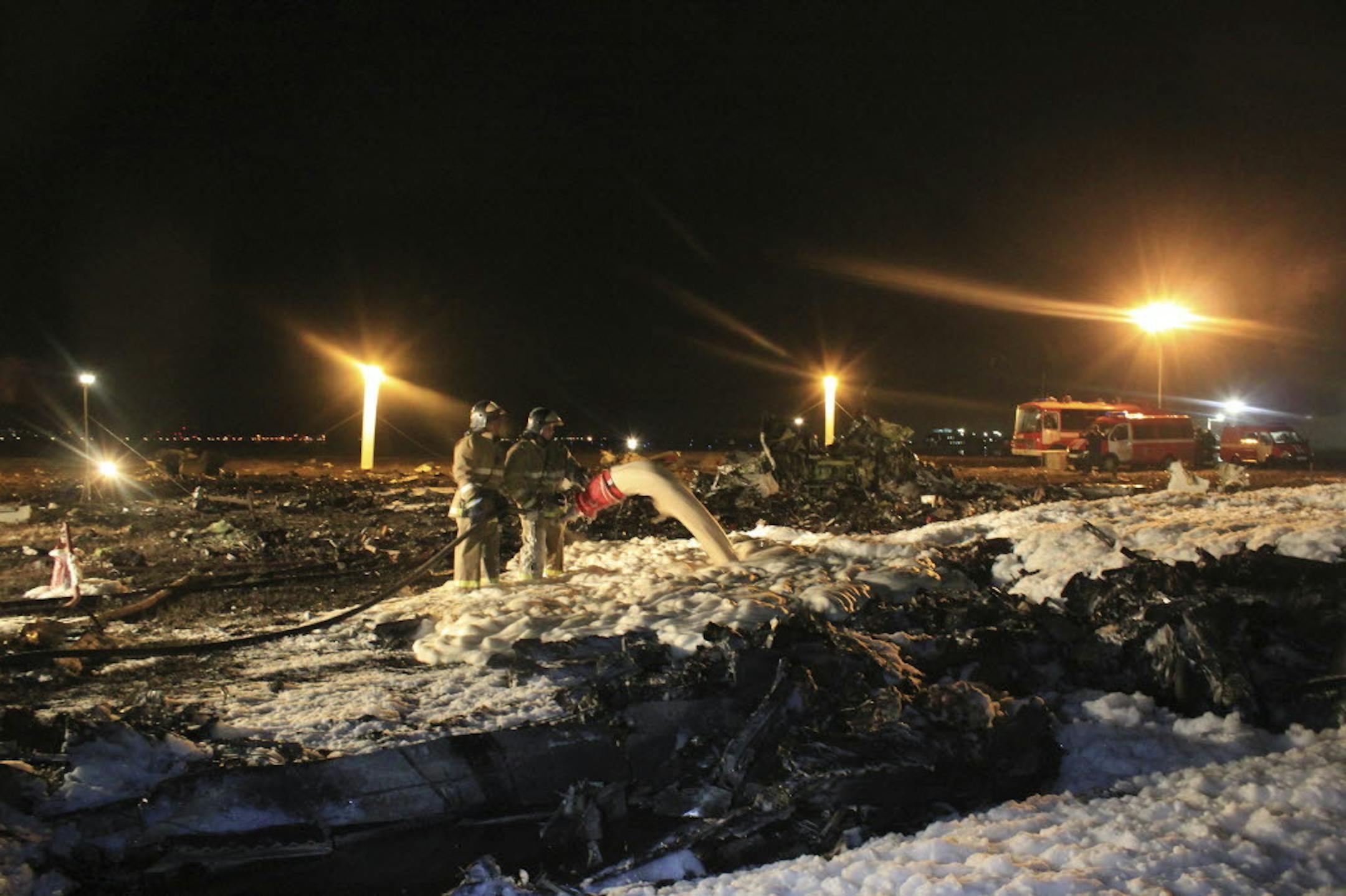 In this photo taken on Sunday, Nov. 17, 2013 and provided by Russian Emergency Situations Ministry fire fighters and rescuers work at the crash site of a Russian passenger airliner near Kazan, the capital of the Tatarstan republic, about 720 kilometers (450 miles) east of Moscow.