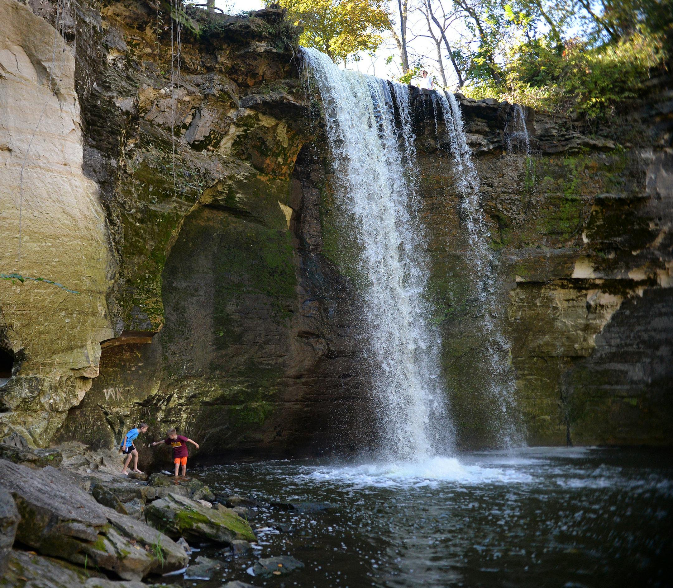 Eric Richards, 9, and Lucas Pieton, 8, cooled off in the waters of Minneopa Falls southwest of Mankato during a visit with Lucas’ mom; cooling-off time may be past, but Minneopa State Park is beautiful in autumn.