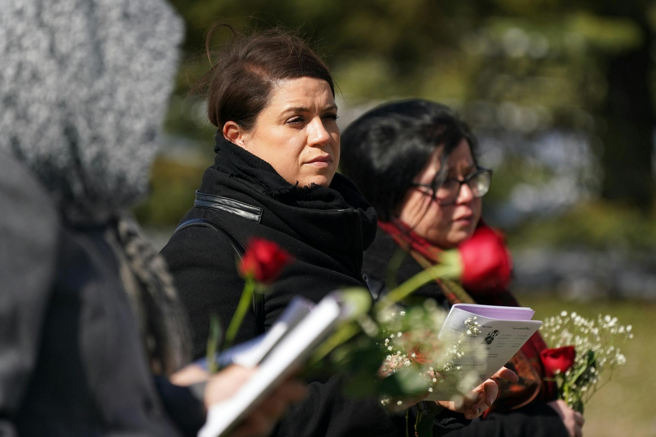 Family and friends including granddaughter Elianne Farhat, center, worked to keep the recommended distancing from one another during funeral services for Elie Farhat, who recently died of COVID-19 at the age of 92, at his gravesite Thursday.