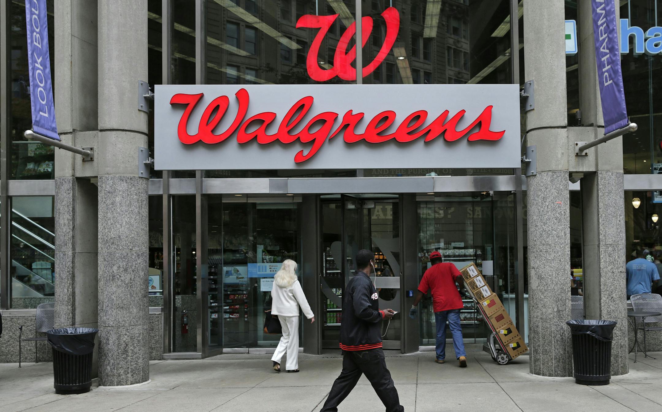 This June 4, 2014 photo shows a Walgreens retail store in Boston. Walgreen Co. _ which bills itself as ‚ÄúAmerica‚Äôs premier pharmacy‚Äù _ is among many companies considering combining operations with foreign businesses to trim their tax bills. These deals, called inversions, have raised concerns among some U.S. lawmakers over the potential for lost tax revenue. (AP Photo/Charles Krupa) ORG XMIT: MIN2014072811071221