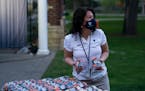 Macalester College president Suzanne Rivera, handing out popcorn at a senior week social event during the pandemic in May 2021.