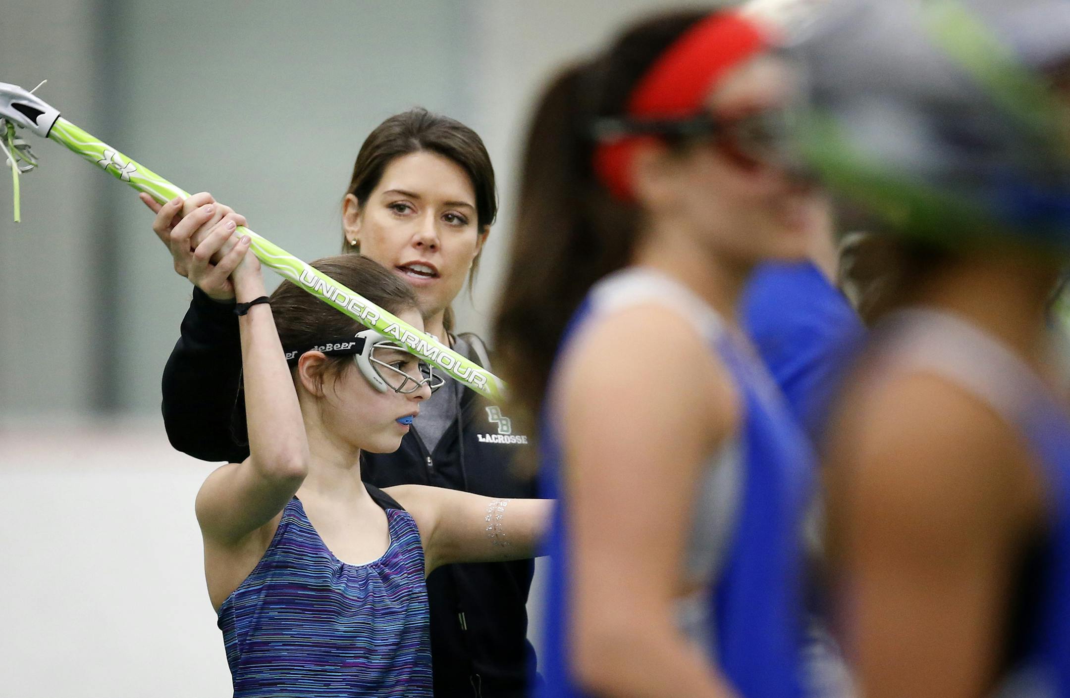 Blake girls lacrosse coach Linda Hokr worked with a player during practice. ] CARLOS GONZALEZ cgonzalez@startribune.com, April 2, 2015, Hopkins, Minn., The Blake girls lacrosse team, which has won five straight state championships, moves on after Laura Mark, the only head coach in team history, resigned to take a different position at the school. We check in with new coach Linda Hokr.