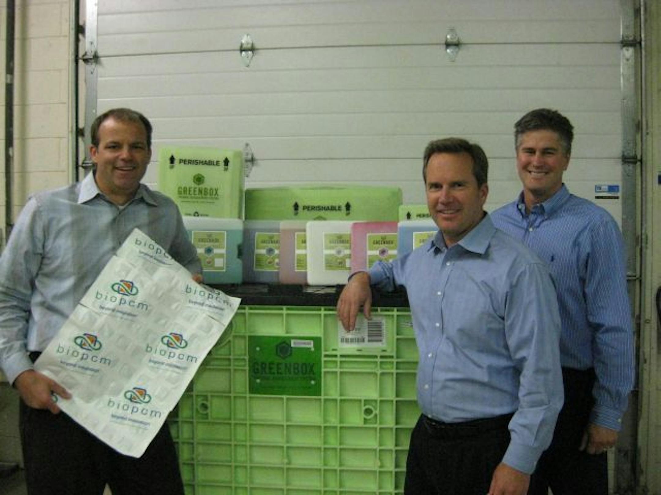 Entropy President Eric Lindquist, left, Steve Skallerud, vice president of sales and marketing, center, and Chris Servais, vice president of operations, with some of the company's container products. Entropy's temperature-control solution is being adapted to heat and cool buildings.