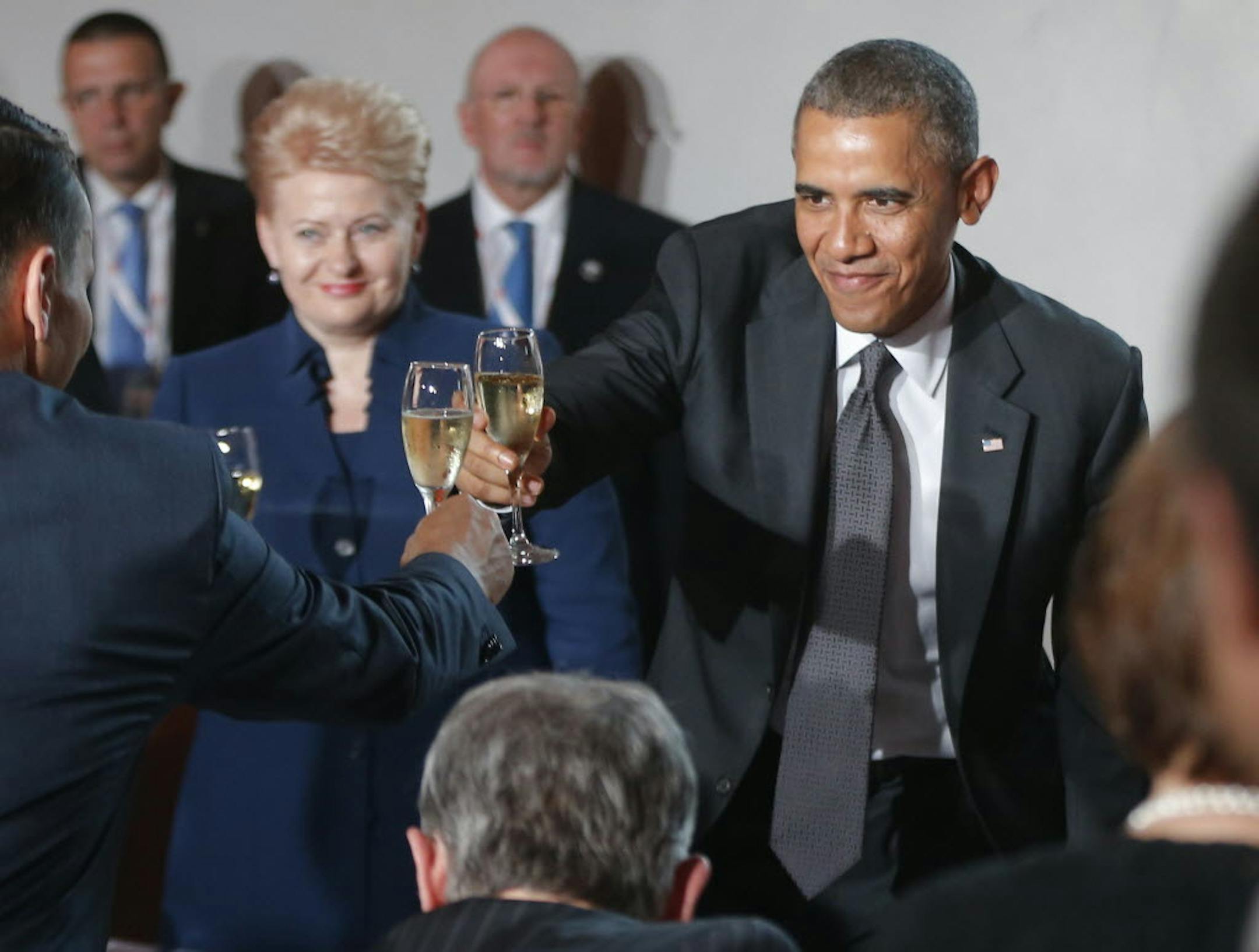 June 3, 2014: U.S. President Barack Obama stands up and toasts as he stands with Lithuania President Dalia Grybauskaite, center, as he attends a dinner at the Royal Castle in Warsaw, Poland.